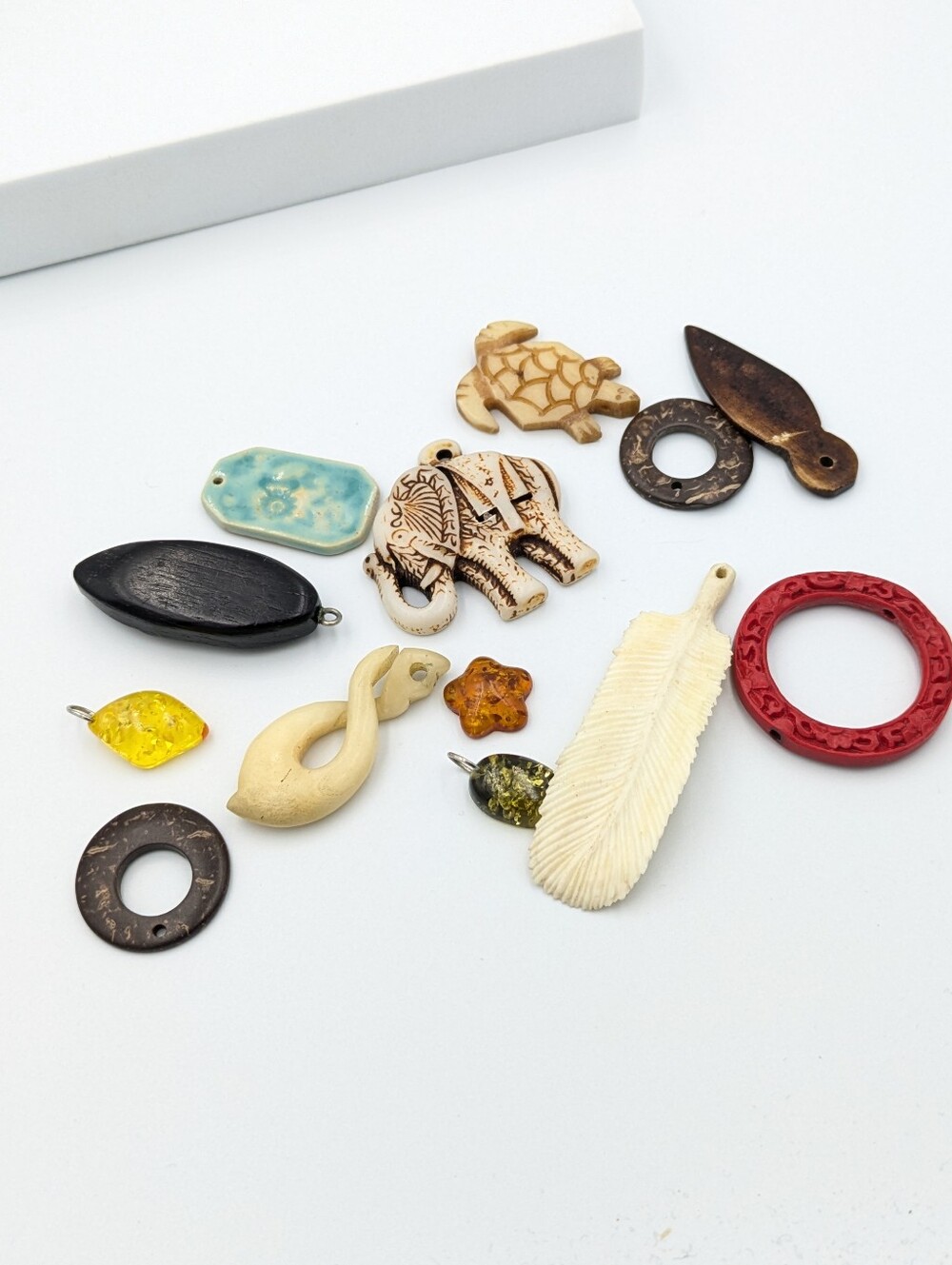 Mix of pendants / beads made from natural material. Wood, bone, etc